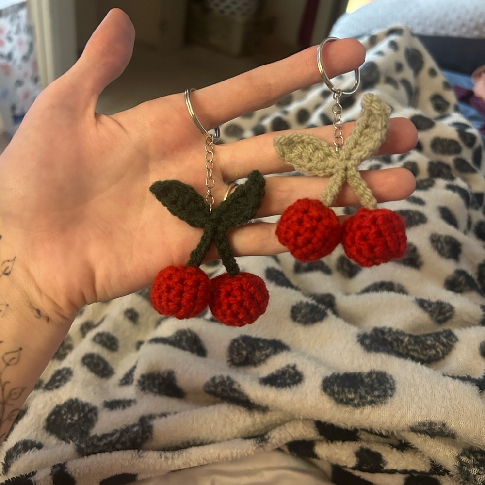 Crochet cherry keychains in pink or red and or dark or light green leaves